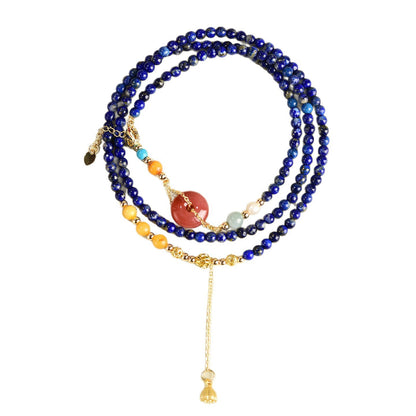 Original lapis lazuli necklace coiled with red agate donut and gold-tone charm