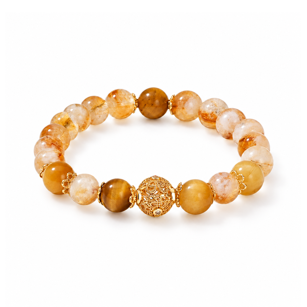 Citrine and tiger eye bracelet with gold-tone filigree center on white background