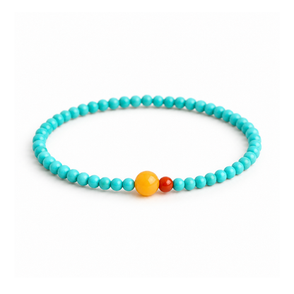 Turquoise and amber 4mm bead bracelet with a red agate accent on white