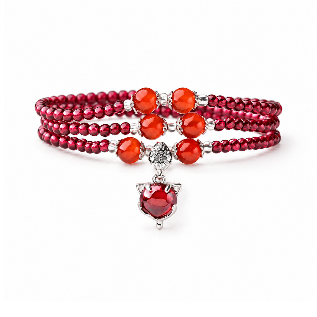 Natural garnet triple-wrap bracelet with six orange-red accents and red fox charm on white