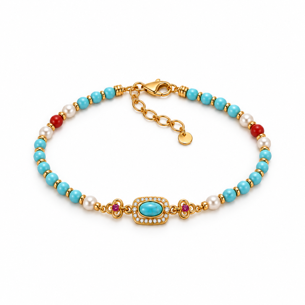 Turquoise-colored bead bracelet with red agate and rhinestone centerpiece on white background