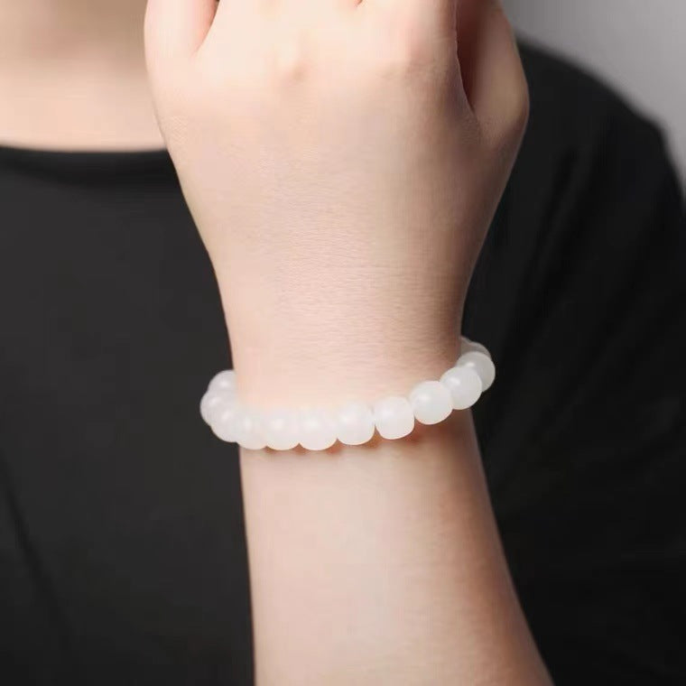 White Hetian jade bead bracelet worn on wrist