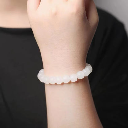 White Hetian jade bead bracelet worn on wrist