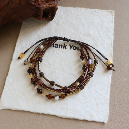 Brown and cream shell bead bracelet with sliding knot