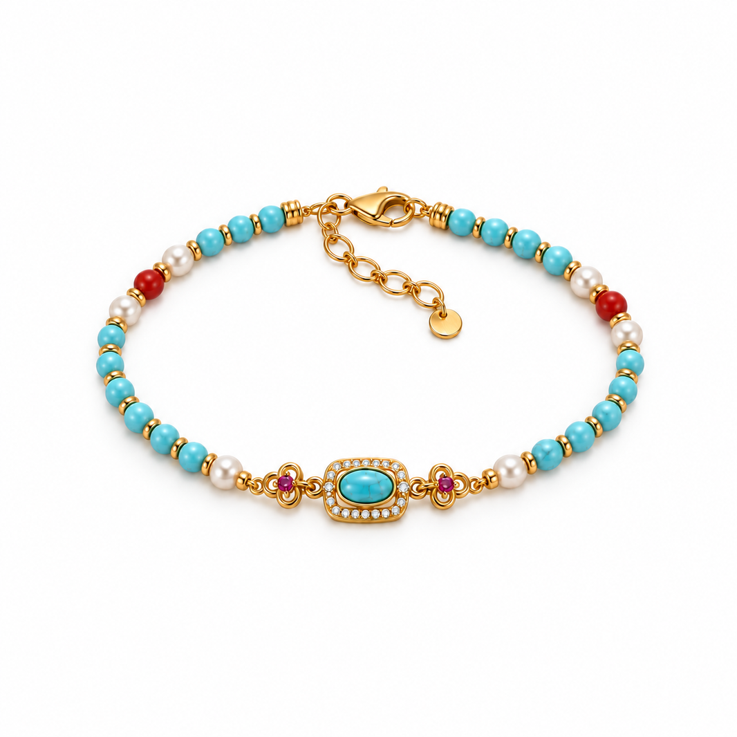 Turquoise-colored bead bracelet with red agate and rhinestone centerpiece on white background