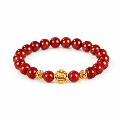 Red cinnabar bracelet with gold-tone traditional motif on white background