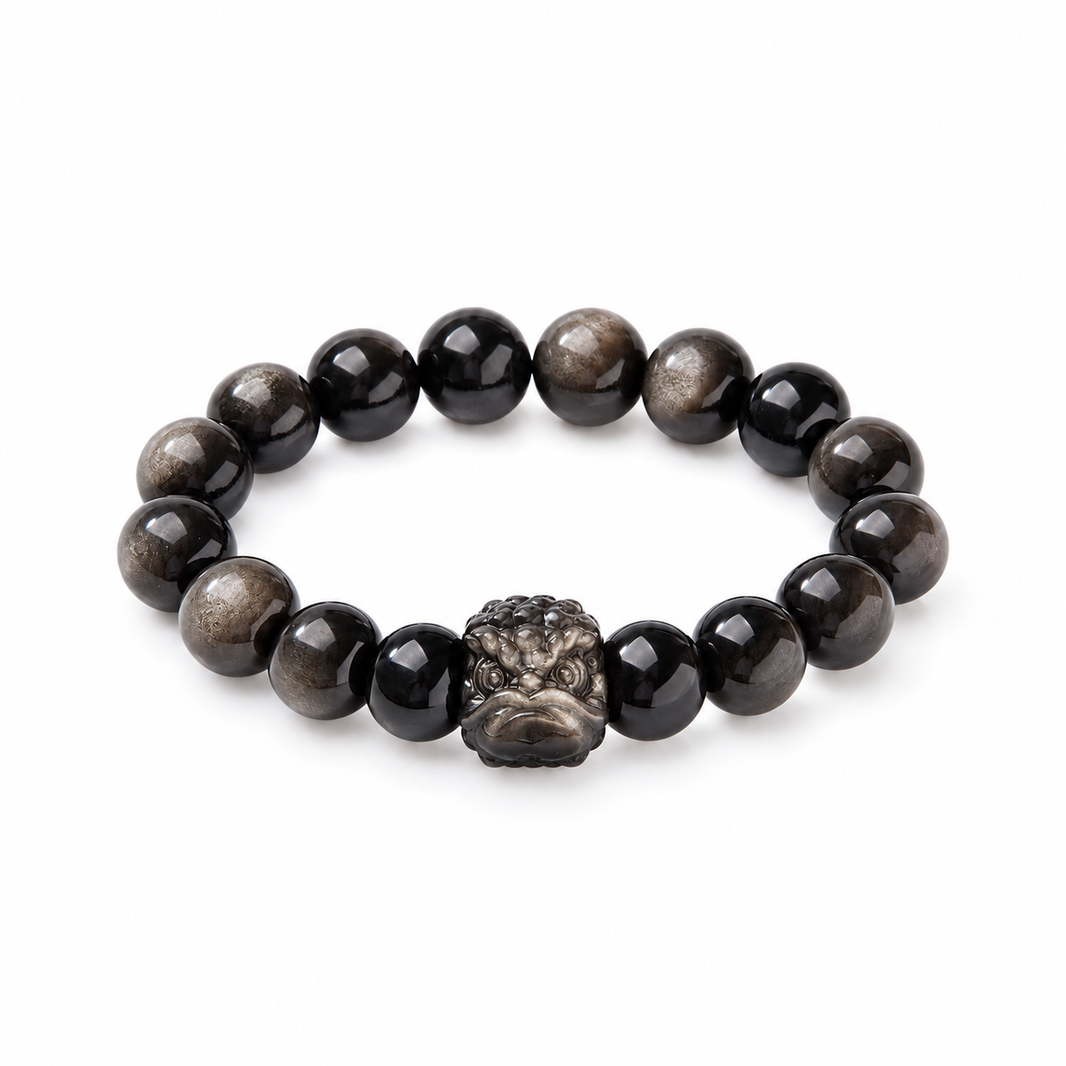 12mm silver-sheen obsidian bracelet with carved lion-dance head on white background