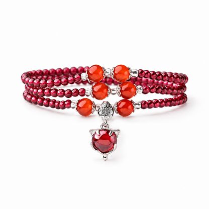 Natural garnet triple-wrap bracelet with six orange-red accents and red fox charm on white