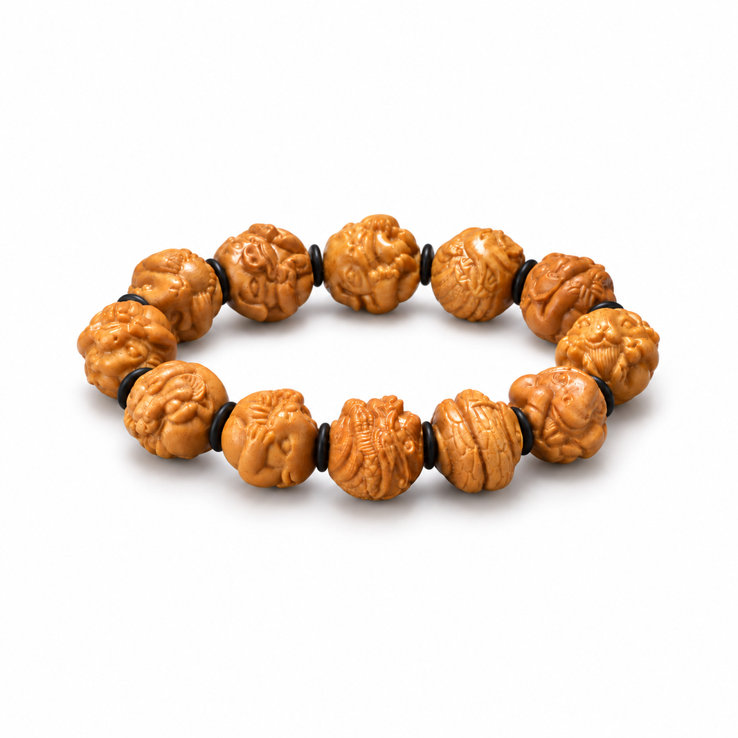 Honey-toned sandalwood zodiac bracelet with carved animal beads and black spacers on white